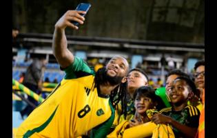 Reggae Boyz midfielder Kasey Palmer takes a selfie with fans at the Jamaica vs Cuba Group B, League A Concacaf Nations League football match at the National Stadium on Friday. 
The game ended 0-0.