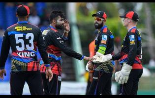 Antigua and Barbuda Falcons’ Imad Wasim (second left) celebrating one of his three wickets against the St Kitts and Nevis Patriots at Warner Park in St Kitts yesterday.