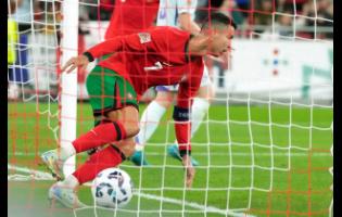 Portugal’s Cristiano Ronaldo celebrates after scoring his side’s second goal during the UEFA Nations League soccer match against Scotland at the Luz stadium in Lisbon, Portugal, yesterday. Portugal won 2-1.