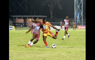 Herbert Morrison Technical High School’s Dantay Morle (left) and Cornwall College’s Carlondo Morris battle for the ball during their opening match of the ISSA/WATA daCosta Cup football competition at the Montego Bay Sports Complex on Saturday, September 7. Cornwall won 4-1.