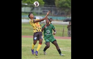 Christopher Hylton (left) of Haile Selassie High School and Jaheim Rankine of Calabar High compete for the ball during their ISSA/WATA Manning Cup football match at Calabar High School on Wednesday. Calabar won 3-0.