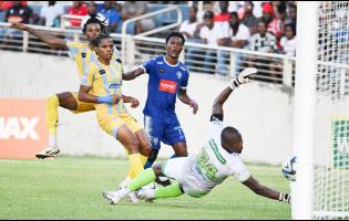 Mount Pleasant’s Devonte Campbell (second right) scores past Waterhouse goalkeeper Kemar Foster during the Jamaica Premier League second leg semifinal  football match at Sabina Park last season. Looking on are Waterhouse midfielder Shemar Boothe (left) and defender Jaheim Brown. Owen Hill, the CEO of Jamaica Premier League Football, says the JPL is the best league in the Caribbean. Story on A30.