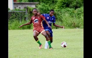 Devonte Bernard of Godfrey Stewart (left) competes with Leanthony Coley (right) of The Manning’s School for the ball during their Zone C match in the ISSA/WATA daCosta Cup at The Manning’s School on Saturday. The Manning’s School won 9-0.