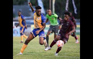 Harbour View’s Odorland Harding pressures Chapelton Maroons’ Malike Stephens during the Jamaica Premier League football match at the Anthony Spaulding Sports Complex on Monday. Chapelton Maroons won 2-1.