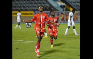 Real Hope’s Steeve Mondestin (left) celebrates after scoring the winning goal against Cavalier during the Concacaf Caribbean Cup match at the National Stadium last night. 