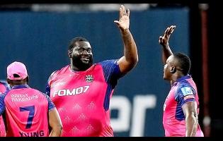 Rahkeem Cornwall (centre) celebrates with the Barbados Royals’ skipper Rovman Powell after claiming a wicket against the St Kitts & Nevis Patriots during the Caribbean Premier League T20 cricket competition at Kensington Oval on Tuesday night. Cornwall took 5-16.