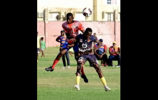 Jahreem McKenzie (left) of Camperdown High School and Kennardo Gordon of St Andrew Technical High School (STATHS) are caught in an aerial battle for the ball during their ISSA/WATA Manning Cup football match at Boys’ Town yesterday. STATHS won 2-0.