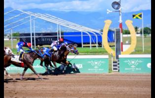 PRINCESS IFIYAH (No.3), ridden by Paul Francis, battles to the wire with MISS LINTON (partly hidden, against the rails) in the fifth race over 5 1/2 furlongs at Caymanas Park on Sunday. MISS LINTON, first past the post, was disqualified for causing interference. The race was awarded to PRINCESS IFIYAH.