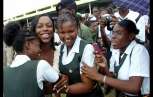 Credit: Rudolph Brown File photo shows legendary Jamaican sprinter Veronica Campbell-Brown (second left) greeting students at her alma mater, Vere Technical High School’s homecoming tour for the Olympians at the school in Clarendon. Campbell-Brown has been supporting the educational efforts of girls at the institution through her VCB Foundation.