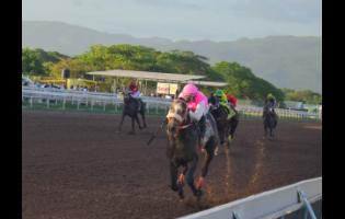 RIDEALLDAY, ridden by United States hall of fame jockey Javier Castellano, winning the fourth running of the Mouttet Mile over eight furlongs at Caymanas Park on Saturday.