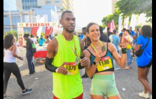 Garfield Gordon (left) and Cecile Heinrich pose after winning the respective men’s and women’s categories in the Reggae Half Marathon, downtown Kingston, yesterday.