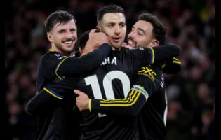 Manchester United players celebrate after a goal during the English Premier League soccer match against Wolverhampton Wanderers in Wolverhampton, England, yesterday. Manchester United won 4-1.