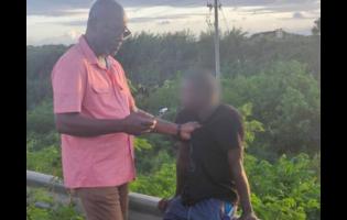 Credit: -Contributed photo Councillor Scean Barnswell (left) detains the man who allegedly abducted a six-year-old girl in Clarendon on December 9, 2025.