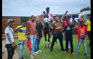 INTRESTINTIMESAHEAD, with Anthony Allen aboard, parades with connections in the winners’ enclosure after landing the third running of the WILL IN CHARGE Trophy at Caymanas Park on Sunday.