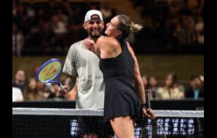 Nick Kyrgios (left) and Aryna Sabalenka interact at the net during their Battle of the Sexes tennis match, in Dubai, United Arab Emirates, on Sunday.