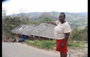 Teacher and businesswoman, Joan Montaque, gestures toward the remains of one of her properties in Litchfield, Trelawny, which collapsed during Hurricane Melissa on October 28.

