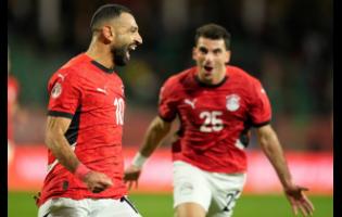 Egypt’s Mohamed Salah (left) celebrates after scoring his team’s third goal against Benin during their Africa Cup of Nations round-of-16 football game in Agadir, Morocco, on Monday. Egypt won 3-1.