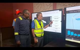 JPS president and CEO Hugh Grant and Energy Minister Daryl Vaz