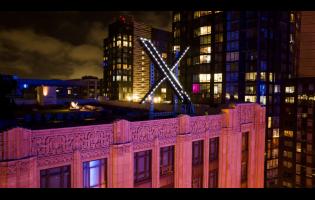 Workers install lighting on an ‘X’ sign atop the company headquarters, formerly known as Twitter, in downtown San Francisco in November 2023. 