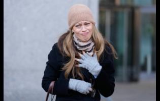 Former record company exec, Drew Dixon, talks to a fan before entering the courthouse in New York, Monday. Her sexual assual case against L. A. Reid was settled on Monday.