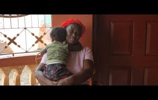 Credit: Simone Morgan-Lindo Grief and comfort intertwine as Janet Henry hugs her 18-month-old grandson.