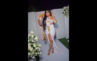 Stunning Nastassia Jackson rocks a white designer dress with gold accents and accessories.