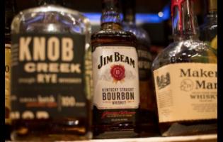 Credit: Jenny Kane FILE - Jim Beam, Knob Creek and other alcohol bottles are pictured at a bar in Eagle, Colo., Dec. 25, 2018. (AP Photo/Jenny Kane, File)