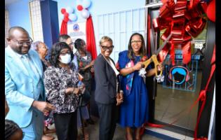 Permanent Secretary in the Ministry of Education, Skills, Youth and Information, Dr Kasan Troupe (right), cuts the ribbon to officially open the Electronic Document Preparation and Management (EDPM) and Customer Engagement Laboratory at Stony Hill Technical High School in St Andrew on January 9. Joining her are State Minister in the Ministry of National Security and Peace and Member of Parliament for St. Andrew West Rural, Juliet Cuthbert Flynn (second right), along with other stakeholders.