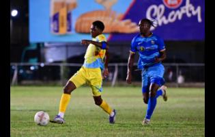 Ky-Mani Campbell of Waterhouse FC dribbles, while being chased by Tyrique Wilson of Molynes United FC during the Jamaica Premier League match at Waterhouse Mini Stadium in St Andrew on Sunday, December 28, 2025.