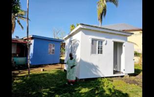 Credit: Contributed Photos Ninety-two-year-old Eugenia Nembhard stands outside her new home in Lacovia, St Elizabeth, made possible through the S Hotel Foundation after Hurricane Melissa left her house severely damaged.