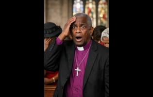 Credit: ChatGPT A clergyman reacts with surprise as women in the church bow their heads. Image created digitally and does not represent any actual individual.