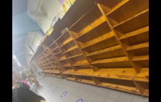 Credit: Ashanti Lawson Shelves stand empty at Kingston Bookshop after emergency crews removed stock to protect it from the smoke of the neighbouring Ammar’s fire.