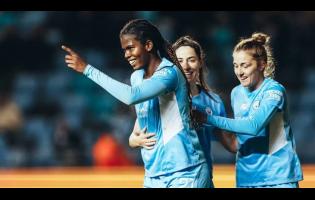 Khadija Shaw (left) celebrates scoring.