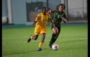 Credit: Courtesy of concacaf.com Aruba Under-17’s Zyana Rogers tries to elude Jamaica’s Phylicia Brown during a Concacaf Women’s U17 qualifier at the Stadion Guillermo Prospero Trinidad on Tuesday.