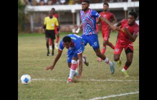 Credit: Ashley Anguin Portmore United’s Tarick Ximines (front) stumbles while coming under pressure from Montego Bay United’s Richardo Ramsey (right) during their Jamaica Premier League football game at Jarrett Park in Montego Bay on Sunday, January 18. Ximines scored Portmore’s winning goal against Cavalier yesterday.