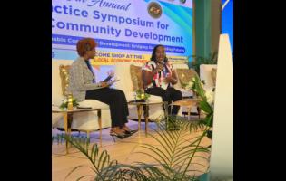 Credit: JIS News Taneka Stewart-Blake (right), former inmate at the South Camp Adult Correctional Centre, tells her story of transformation during the recent Planning Institute of Jamaica (PIOJ) Best Practice Symposium held at The Jamaica Pegasus hotel in New Kingston. Listening is interviewer, Rochelle Whyte.