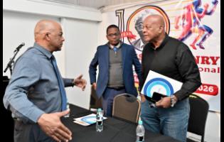 Leroy Cooke (left), chairman of the Local Organising Committee of SW Isaac-Henry Track and Field Invitational meet, chats with Dr Worrell Hibbert (centre), principal of St Andrew Technical High, and Brian Smith, JAAA executive member, at the launch of the SW Isaac-Henry Track and Field Invitational meet at the S Hotel in New Kingston yesterday.