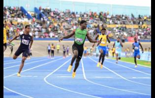 Calabar High’s Khamani Gordon (second left) crosses the line ahead of the field in the Class One 4x100m final at the 2025 Gibson McCook Relays at the National Stadium.