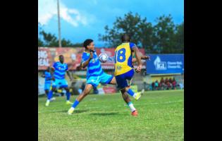 Raje Ximines of Harbour View FC (right) kicks the ball as Odane Murray of Molynes United reacts during the Jamaica Premier League football match at Waterhouse Mini Stadium in Kingston on Monday. The game ended 2-2.