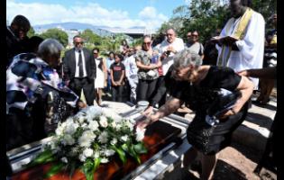 Mourners lay flowers on the casket of Melissa Silvera at her funeral in 2024.