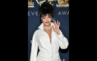 FILE - Rihanna attends the 38th annual Footwear News Achievement Awards at Cipriani South Street on Wednesday, Dec. 4, 2024, in New York. (Photo by Evan Agostini/Invision/AP, File)