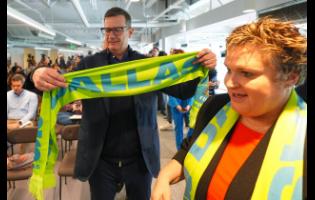 Heimo Schirgi, FIFA soccer chief event operations officer (left), looks at a fan scarf with Monica Paul, North Texas organising committee president, during a news conference announcing the 2026 FIFA World Cup Fan Festival soccer experience in Dallas on Monday.