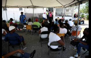 Patients wait to be served out the eye clinic at St Joseph’s Hospital in Kingston yesterday.
