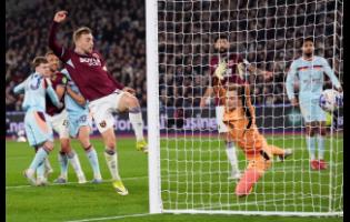 West Ham United’s Jarrod Bowen scores during the English FA Cup fifth-round soccer match against Brentford in London, England, on Monday.