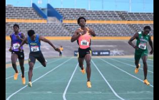 Hydel High School’s Junior Gallimore (second left) dips at the tape to finish second in a personal best 45.87 seconds behind Zachary Wallace (third left), unattached, who won in a personal best of 45.77 in the Under-20 boys’ 400 metres final at Carifta Trials at the National Stadium in Kingston on Saturday, March 7.