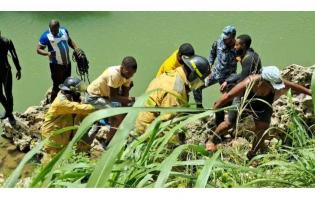 Firefigthers removing the body of a teen boy who died the vehicle he was driving plunged into the Rio Cobre in St Catherine on Monday, March 16, 2026.