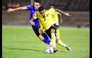 Jamaica’s Leon Bailey (right) is challenged by El Salvador's Luis Vasquez during a Concacaf World Cup Qualifier  at the National Stadium on Thursday, March 24, 2022. 