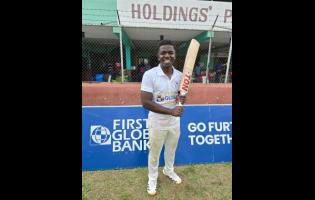 St Jago captain Vitel Lawes is all smiles after leading his side to the First Global Bank Grace Shield title in a game against Campion College at Melbourne Cricket Oval yesterday.