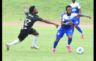 Demario Phillips (right) of Mount Pleasant FA dribbles past Kimarly Scott of Cavalier SC during their Jamaica Premier League football match at Stadium East on Thursday.