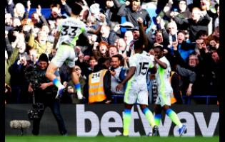 Manchester City’s Nico O’Reilly (left) celebrates after scoring during the English  Premier League soccer match against Chelsea in London, England, on Sunday.